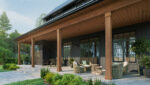 Classic, modern farmhouse front porch featuring dark vertical siding, warm wood column wraps and ceiling.