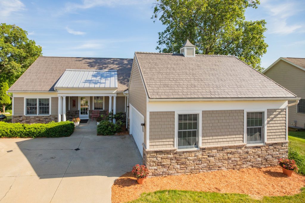 Home exterior featuring Versetta Stone veneer in a Tight-Cut profile and Plum Creek color, requiring only occasional, gentle washing to preserve its natural texture.