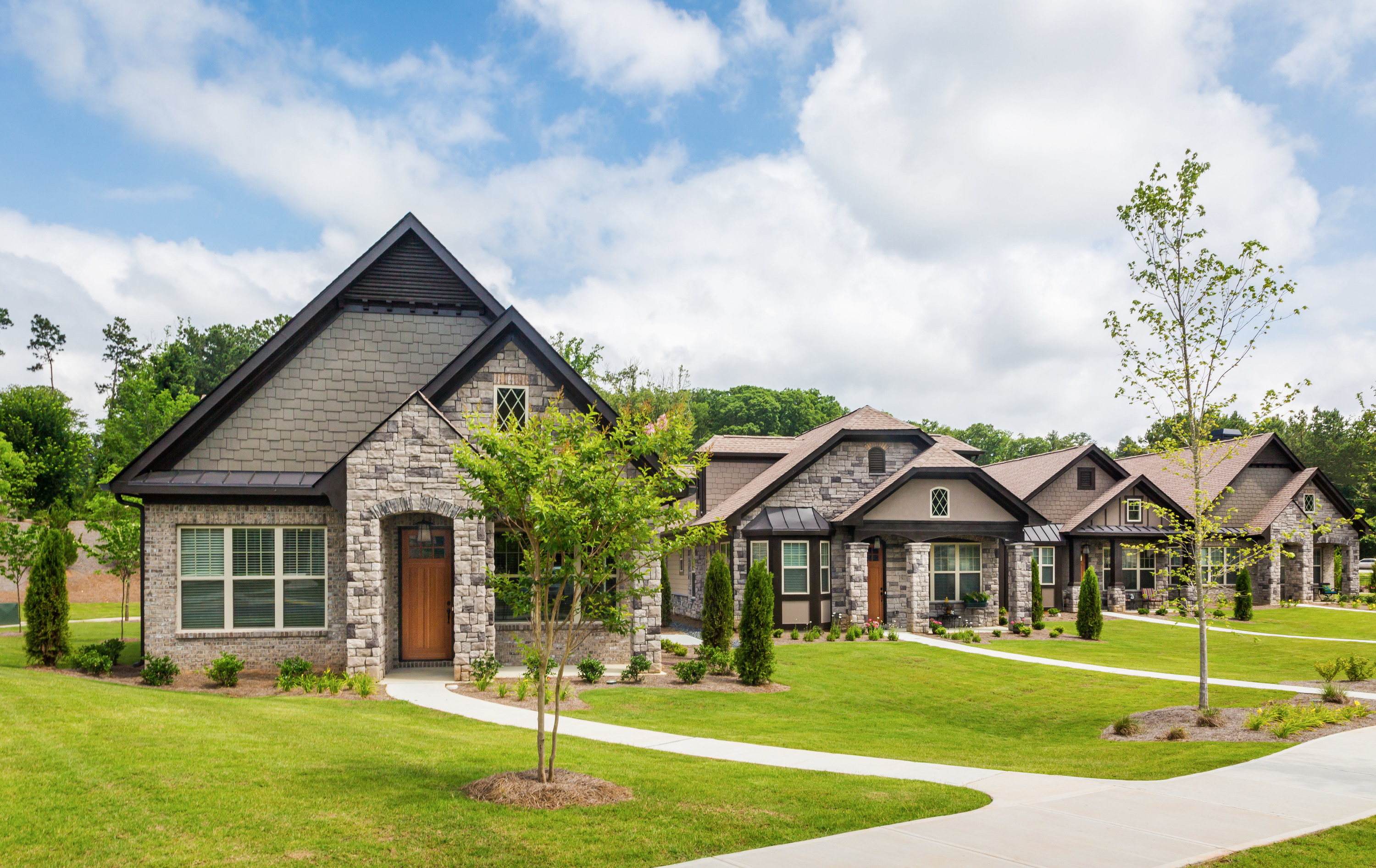 Row of houses with stone and siding exteriors.