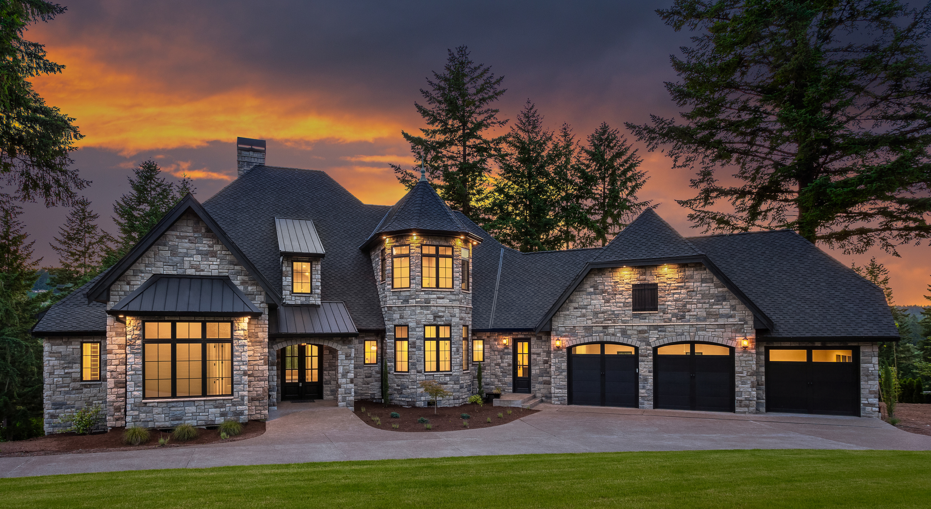 Large stone house with a castle-like design at sunset.