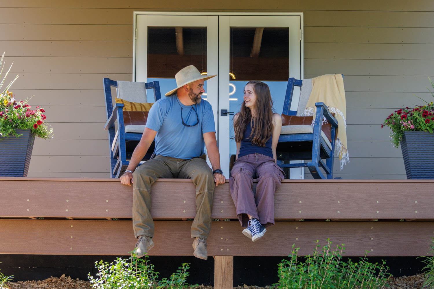 Jared Capp and daughter Sprout on the porch of Cabin #15
